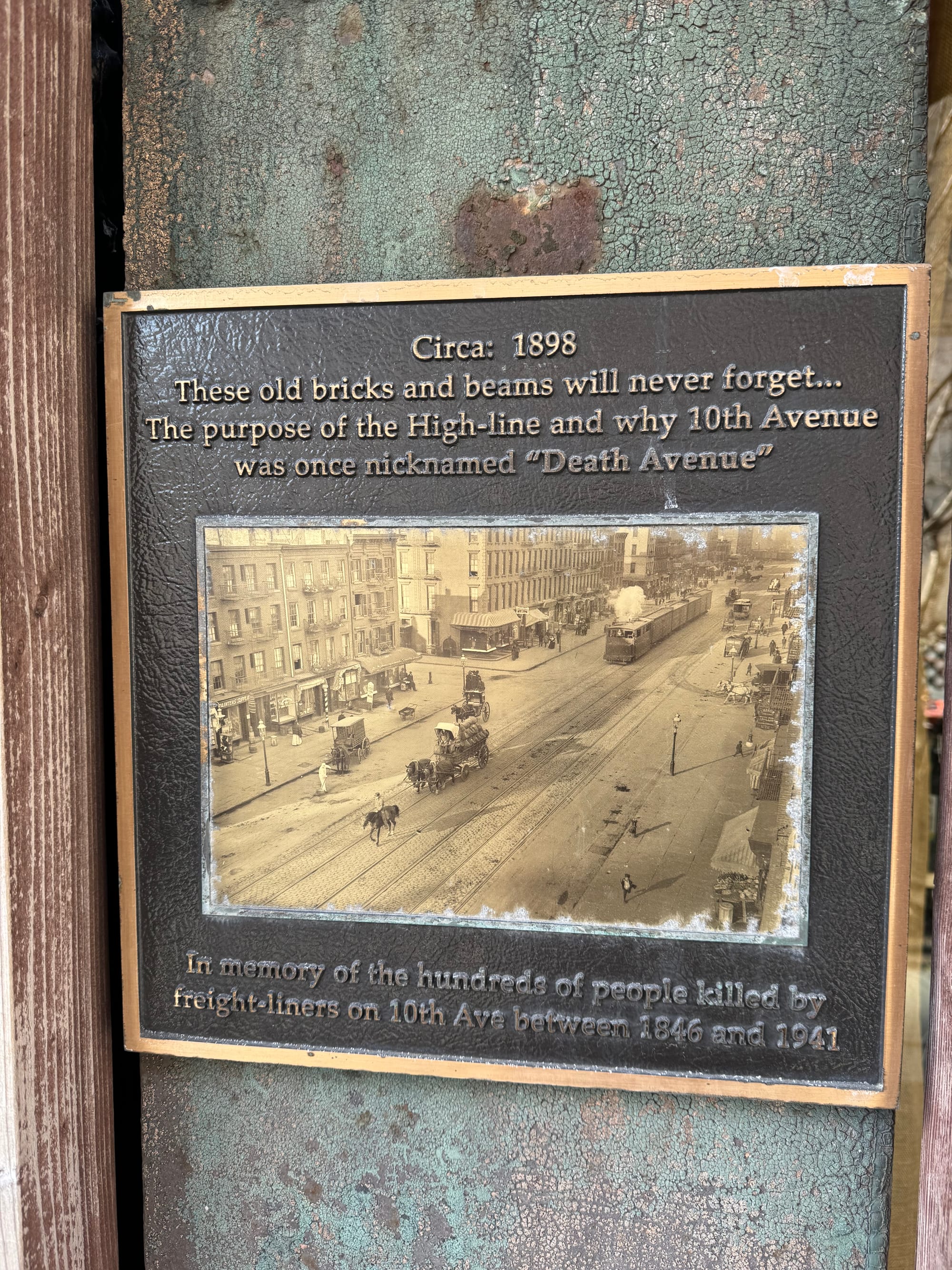 A metal plaque with a picture of 10th avenue in 1898, with a caption that says, "In memory of the hundreds of people killed by freight-liners on 10th Ave between 1846 and 1941. 